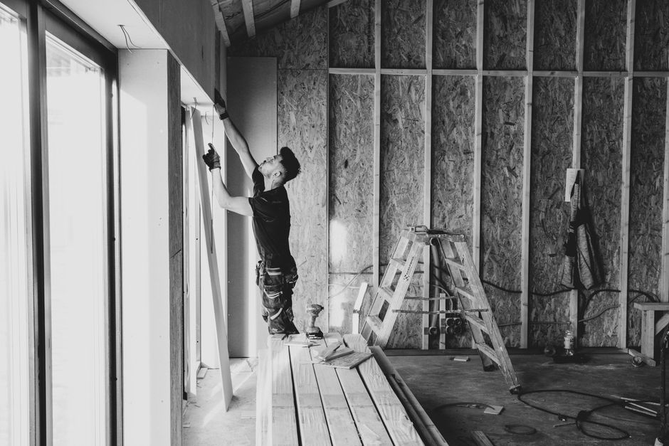 Professional window installation contractor working on a residential project